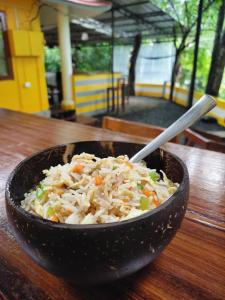 a bowl of rice and vegetables on a table at Hope Hostels - Munnar in Munnar