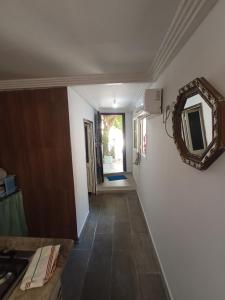 a hallway with a mirror on the wall and a hallway sidx sidx sidx at Maison Kram Plage in Le Kram