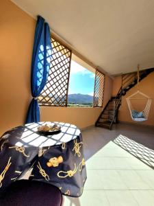 a room with a table and a window and a staircase at Leoncorno la Marina a Villasimius in Villasimius +15 photos