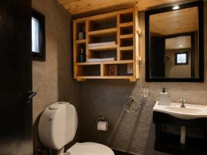 a bathroom with a toilet and a sink at Tierras Mágicas in Villa Pehuenia +35 photos