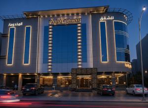 a building with cars parked in front of it at Al Quba Palace Serviced Apartments in Riyadh