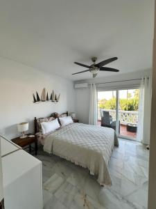 a bedroom with a bed and a ceiling fan at Casa Costa del Sol Beach&Golf,Marbella in Sitio de Calahonda