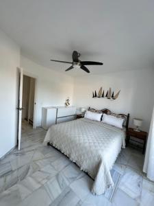 a bedroom with a bed and a ceiling fan at Casa Costa del Sol Beach&Golf,Marbella in Sitio de Calahonda