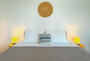 a bedroom with a bed with white pillows at Oliaros Seaside Lodge in Agios Georgios