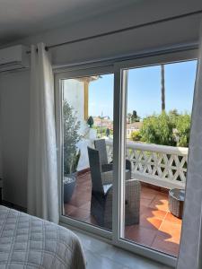 a bedroom with a sliding glass door to a balcony at Casa Costa del Sol Beach&Golf,Marbella in Sitio de Calahonda +88 photos