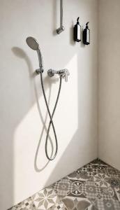 a shower in a bathroom with a tile floor at Oliaros Seaside Lodge in Agios Georgios +46 photos