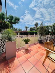 a patio with potted plants and a wooden fence at Casa Costa del Sol Beach&Golf,Marbella in Sitio de Calahonda