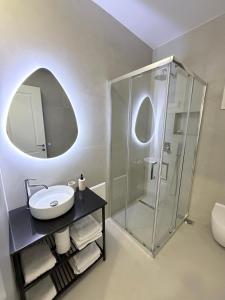 a bathroom with a sink and a shower at Oasis in Vlorë +32 photos