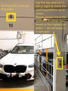a white bmw car in a parking lot at Your home with iconic TV tower views in Stuttgart