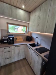 a small kitchen with a sink and a window at Riverside Sauna House in Savala