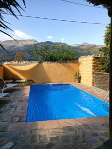 a swimming pool with a view of the mountains at Casas Amaro in Órgiva