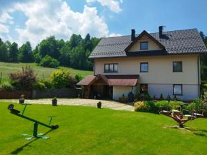 a large white house with a large yard at Dom w górach na wyłączność Agro Zibi in Korbielów