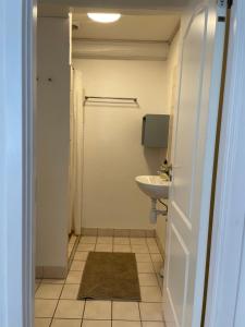 a small bathroom with a sink and a toilet at Davinde Gæstgiveri in Odense +18 photos
