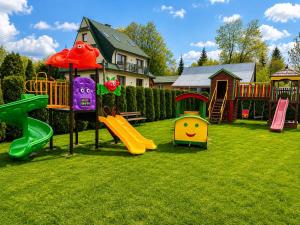 a playground with different types of play equipment in a yard at Pokoje u Wojtanka in Białka Tatrzańska
