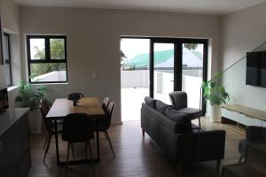 a kitchen and dining room with a table and chairs at Simons Town long beach Penthouse in Simonʼs Town