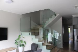 a staircase in a living room with a chair at Simons Town long beach Penthouse in Simonʼs Town