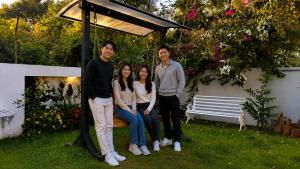 a group of three people sitting on a bench at De Majestic Grand Villa in Auroville +16 photos
