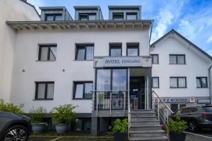 a white building with a sign that reads hotel influencing at Hotel Mykonos in Eschweiler +23 photos
