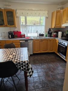 a kitchen with a table and a sink at Kríukot íbúð in Hólmavík +16 photos