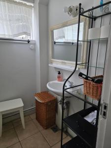 a bathroom with a sink and a toilet and a window at Kríukot íbúð in Hólmavík