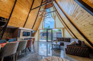 an open living room with a vaulted ceiling at Qafqaz Rolling Bungalow in Gabala