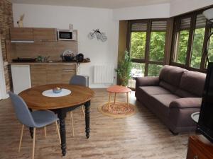 a living room with a table and a couch at briand in Charleville-Mézières