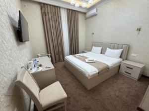 a hotel room with a bed and a chair at Toj Mahal Hotel in Takchilik +61 photos