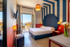 ein Schlafzimmer mit Bett und Balkon in der Unterkunft Hotel Doria in Cavi di Lavagna