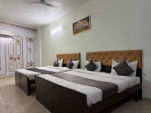 a bedroom with two beds in a room at HOTEL The Puadh Stay in Lāndrān
