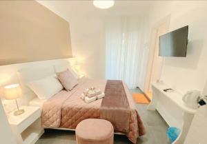 a small bedroom with a bed and a television at ALBATROS Suites&Rooms in Naples