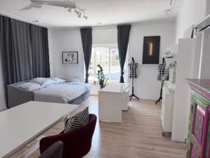 a living room with a bed and a table at Wohnstudio Millstatt in Millstatt