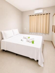 a bedroom with a large white bed in a room at Brisa do Preá- 700m da Praia do Preá -12km de Jeri in Prea