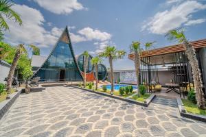 a resort with a playground and palm trees at Qafqaz Rolling Bungalow in Gabala