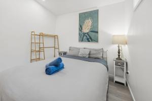 a bedroom with a blue teddy bear sitting on a bed at Lovely Hidden Gem in Redcliffe in Redcliffe
