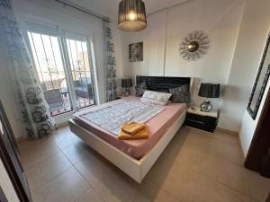 a bedroom with a bed and a large window at Altos Bahia Magic in Torrevieja +22 photos