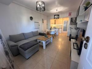 a living room with a couch and a table at Altos Bahia Magic in Torrevieja