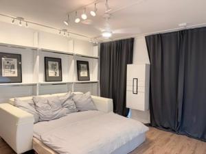 a bedroom with a white bed in a room at Wohnstudio Millstatt in Millstatt