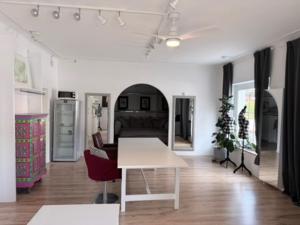a living room with a white table and chairs at Wohnstudio Millstatt in Millstatt +31 photos