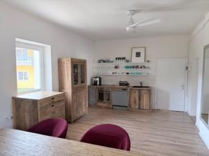 a kitchen with a table and chairs in a room at Wohnstudio Millstatt in Millstatt