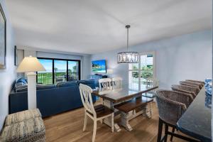 a living room with a table and a blue couch at South Seas Beach Villa 2428 in Captiva