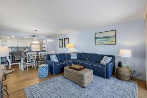 a living room with a blue couch and a kitchen at South Seas Beach Villa 2428 in Captiva
