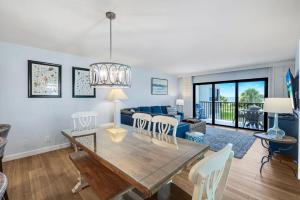 a dining room and living room with a table and chairs at South Seas Beach Villa 2428 in Captiva +21 photos