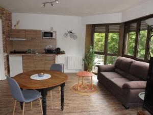 a living room with a couch and a table at briand in Charleville-Mézières +3 photos