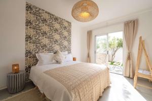 a bedroom with a bed with a floral accent wall at Villa Sahel Bleu in Essaouira