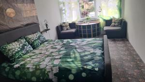 a bedroom with a bed and two chairs at APPLE PARADISE, House of mirrors, self check-in, FREE PARKING in Riga