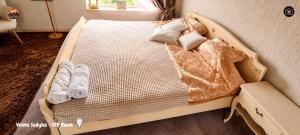 a bed with towels and pillows on it at Vilimu Sodyba - VIP Room in Kriukai
