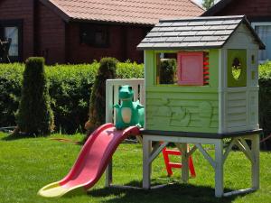 a toy house on top of a slide at Arcada in Jarosławiec +48 photos