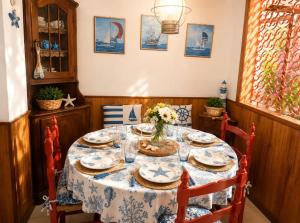 a dining room table with a blue and white table cloth at Sea Horse in Lido di Camaiore