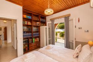a bedroom with a bed and a book shelf at Ilia's Holiday Home in Perítheia