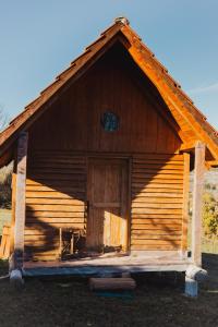 a large wooden building with a large door at IMANJE JELEN in Nikšić